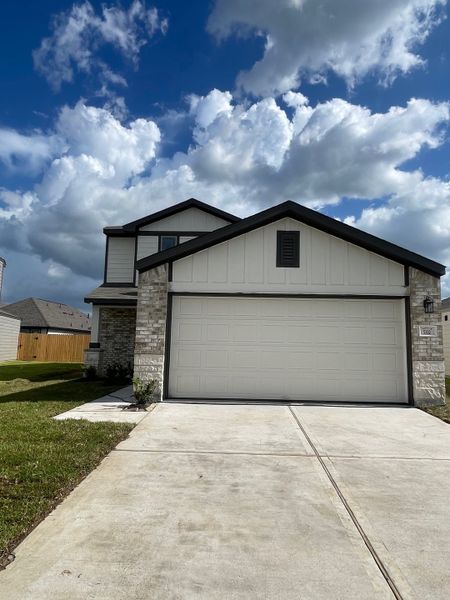 A modern two-story home with a spacious driveway in Sandrock Station by First America Homes (Houston, TX). A modern two-story home with a spacious driveway in Sandrock Station by First America Homes (Houston, TX).