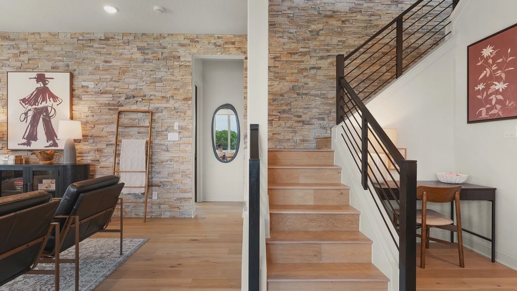 Sleek warm-toned staircase with a modern black railing creates an architectural statement.