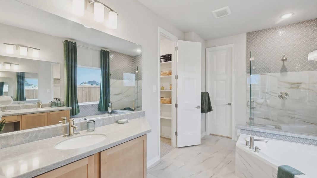 Opulent marble tiles and elegant fixtures elevate this Wildflower Ranch bathroom to unmatched luxury. Opulent marble tiles and elegant fixtures elevate this Wildflower Ranch bathroom to unmatched luxury.