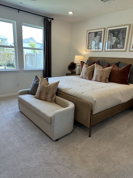 A cozy bedroom with a plush bed, elegant bench seating, and modern decor, featuring large windows for abundant natural light. A cozy bedroom with a plush bed, elegant bench seating, and modern decor, featuring large windows for abundant natural light.