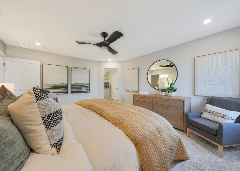 A bedroom with a bed and a fan. A bedroom with a bed and a fan.