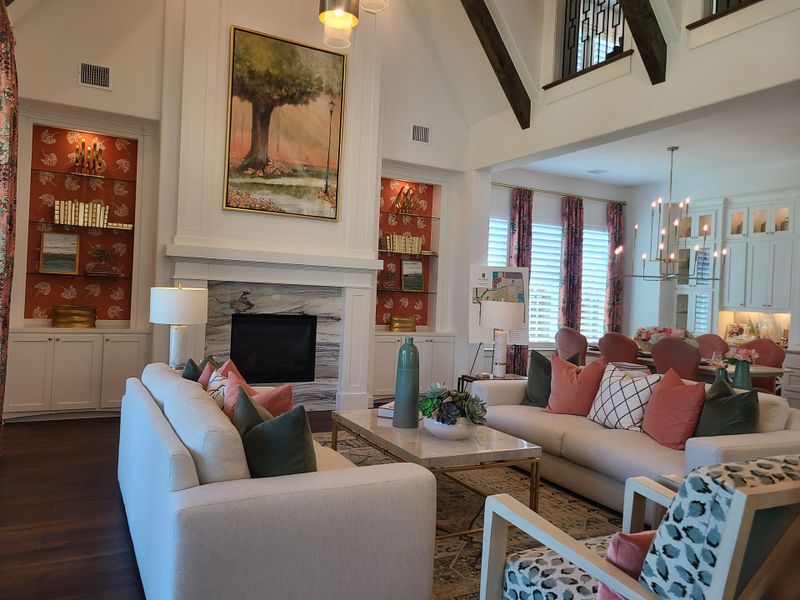 A spacious living area featuring elegant decor, a vaulted ceiling with beams, and a cozy fireplace for a warm ambiance. A spacious living area featuring elegant decor, a vaulted ceiling with beams, and a cozy fireplace for a warm ambiance.