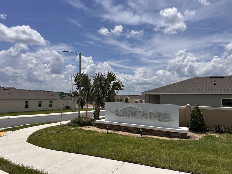 A welcoming entrance to Cascades by D.R. Horton, featuring a manicured landscape in Davenport, FL.