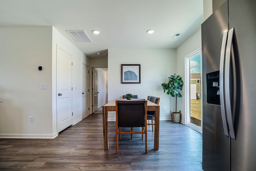 A room with a table and chairs.