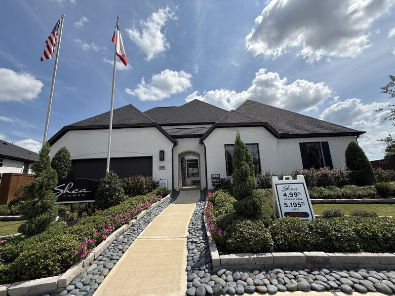 Elegant white brick home with lush landscaping in Meridiana 70' by Shea Homes (Manvel, TX). Elegant white brick home with lush landscaping in Meridiana 70' by Shea Homes (Manvel, TX).