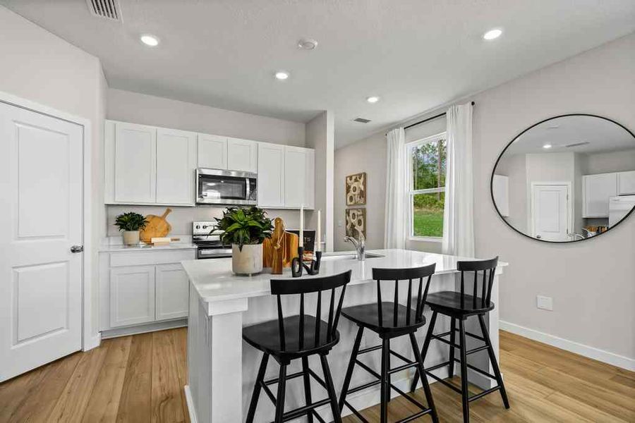 A kitchen with white cabinets. A kitchen with white cabinets.
