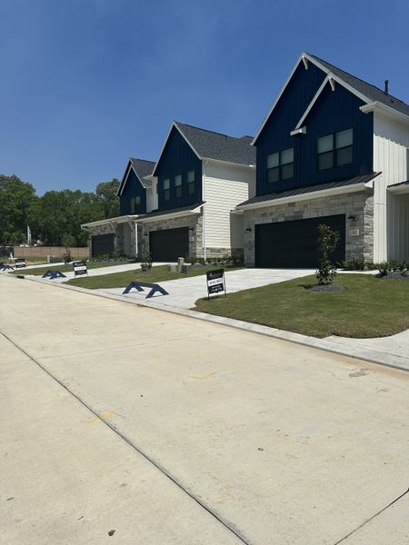 Modern homes with dark accents and landscaped yards in Summer Place 35' by Tricoast Homes (Montgomery, TX).