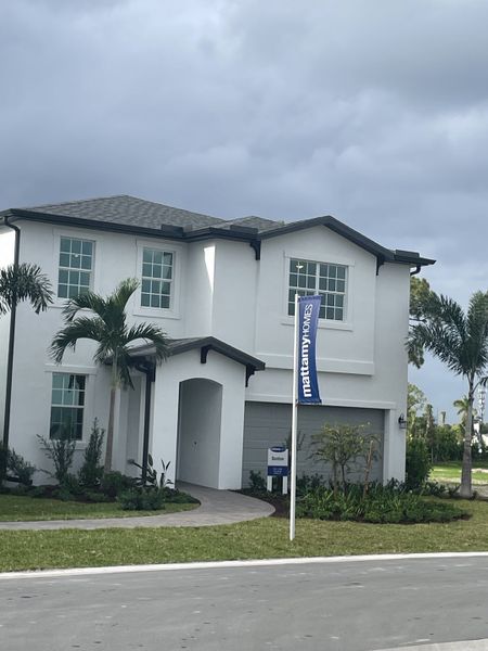 Stylish white modern home with tropical landscaping in Forest – Townhomes by Mattamy Homes (Lake Worth, FL).