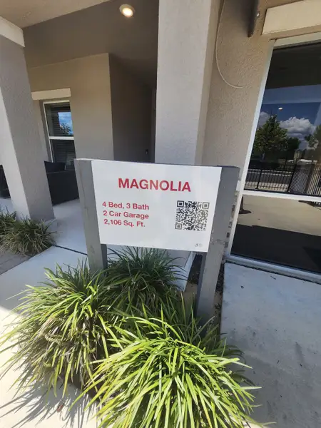A modern new home entry in Marion Creek by Taylor Morrison, featuring a covered porch and lush landscaping in Haines City, FL.