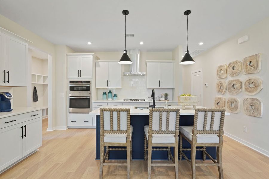 Large kitchen island with seating creates a central hub for meals, prep, and connection