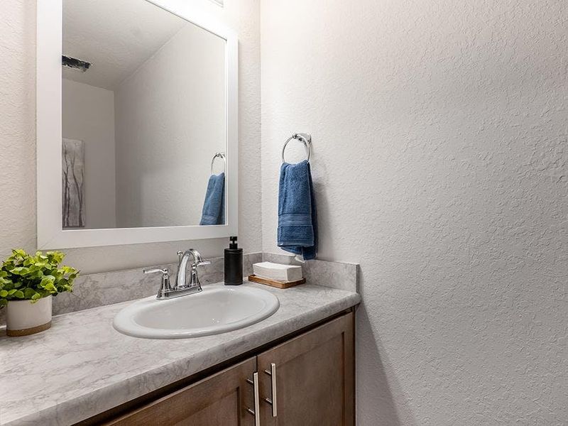 And, a convenient downstairs powder room serves your guests - Azalea townhome model in St. Cloud, FL