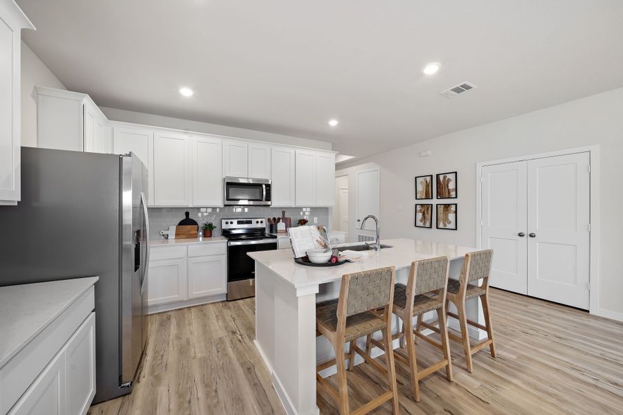 A kitchen with white cabinets. A kitchen with white cabinets.