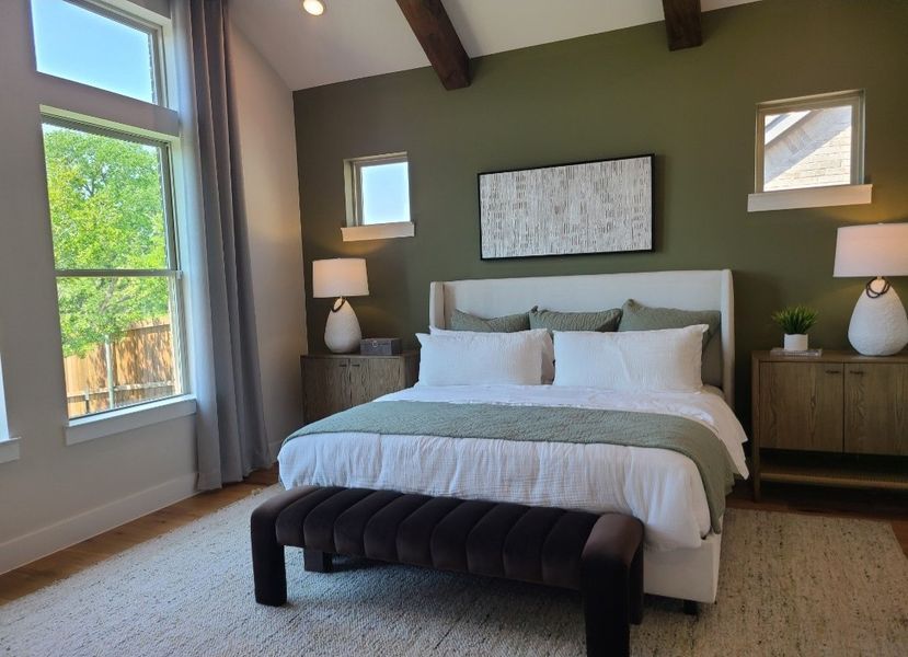 A cozy bedroom featuring a green accent wall, wooden beams, and elegant furnishings. A cozy bedroom featuring a green accent wall, wooden beams, and elegant furnishings.