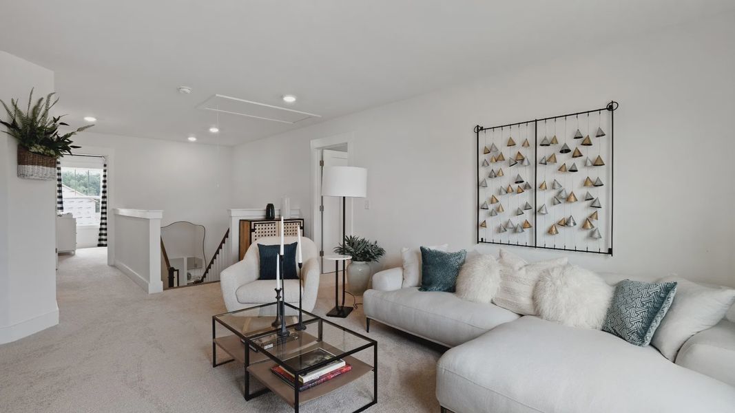 Cozy, plush carpeted bonus room with large windows at Walnut Ridge by DRB Homes in Inman, SC