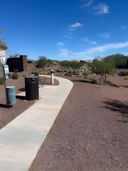 A serene desert pathway with modern amenities in The Enclaves at Desert Oasis by KB Home (Surprise, AZ). A serene desert pathway with modern amenities in The Enclaves at Desert Oasis by KB Home (Surprise, AZ).