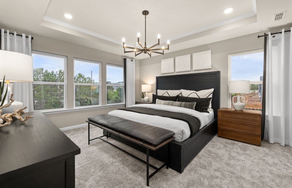 Modern spacious owner's suite with tray ceiling new home construction at Prestwick in Apex, NC