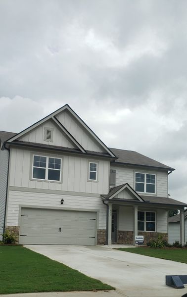 A charming modern home with a sleek facade and landscaped yard in Fairhaven by D.R. Horton (Lithia Springs, GA).