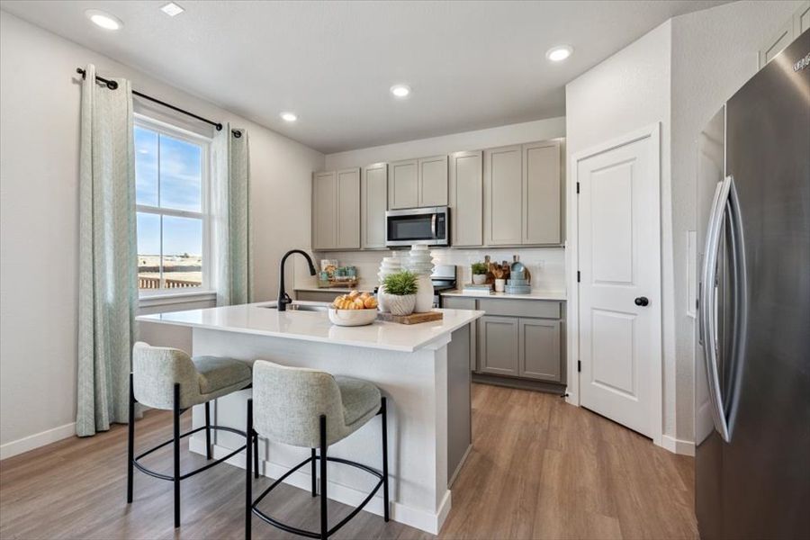 A kitchen with white cabinets.