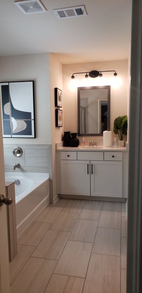 A stylish bathroom with a modern vanity, sleek fixtures, and elegant wall art for a touch of sophistication.