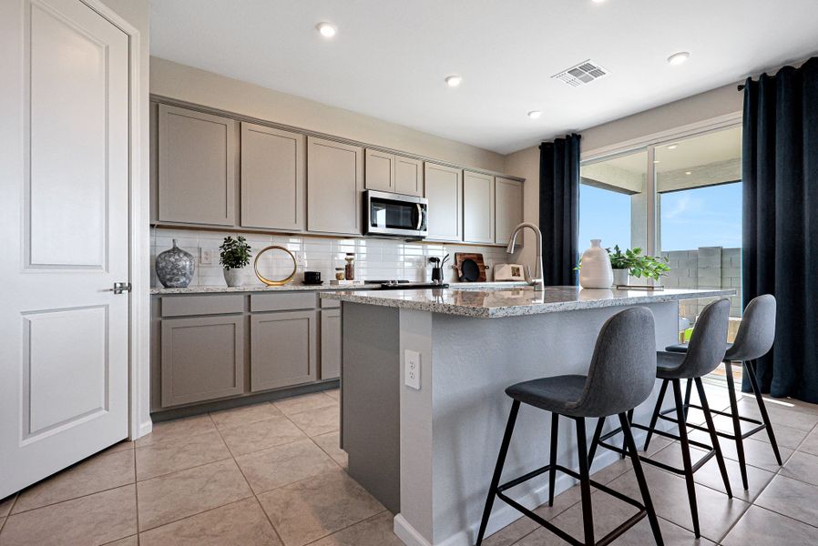 A kitchen with a marble island. A kitchen with a marble island.