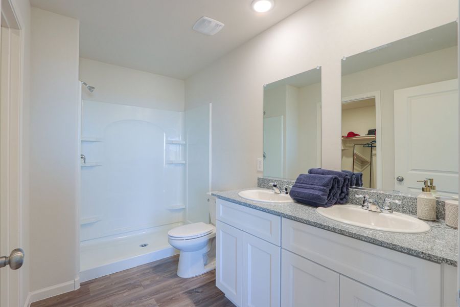 A bathroom with a tub sink and toilet. A bathroom with a tub sink and toilet.