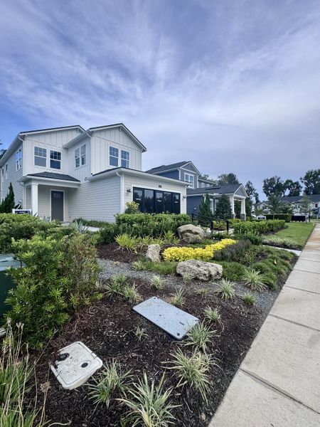 A modern two-story home with lush landscaping in RiverTown - Meadows by Mattamy Homes (St. Johns, FL).