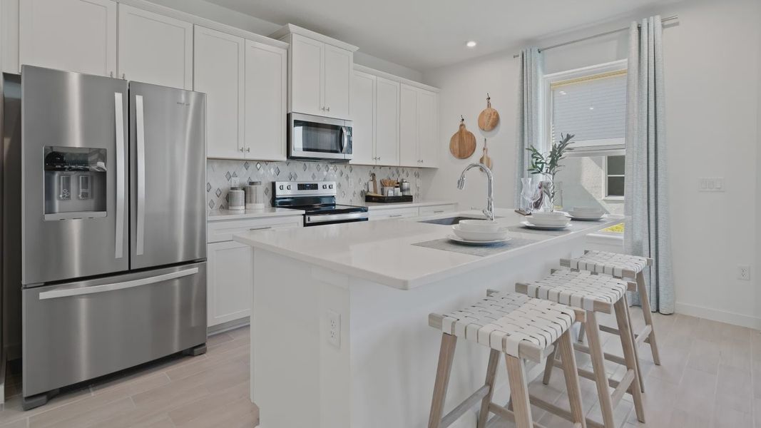 Open kitchen with sleek white cabinets, clean lines, and a bright, modern feel—perfect for cooking and gathering.