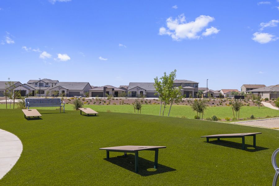Cornhole entertainment and park benches at El Cidro.