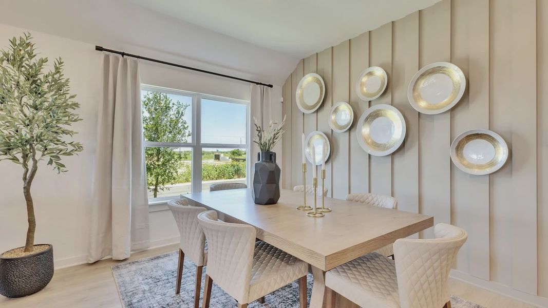 Experience luxury with quilted chairs, a light wood table, and stylish wall art in Hunters Glen. Experience luxury with quilted chairs, a light wood table, and stylish wall art in Hunters Glen.