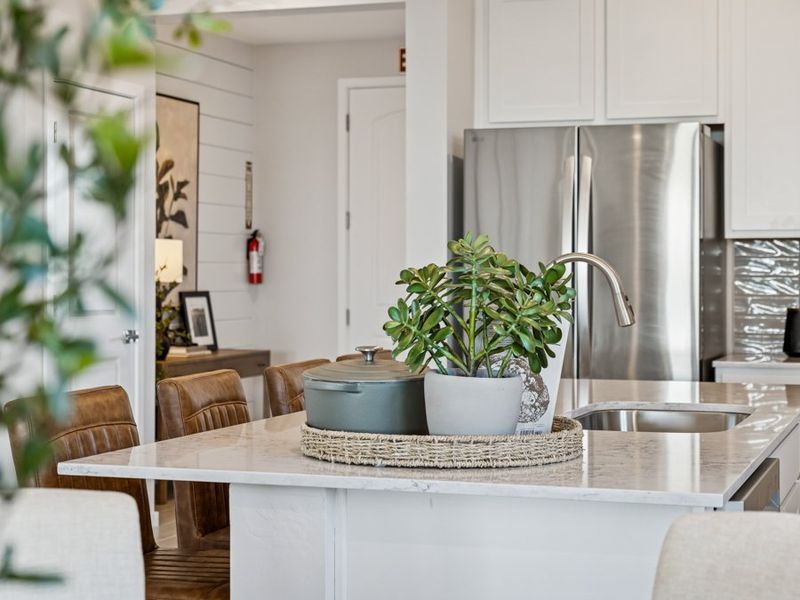 A kitchen with a table and chairs. A kitchen with a table and chairs.