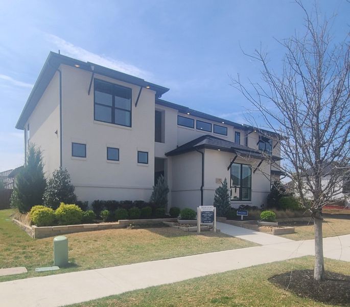 A modern two-story home with a manicured lawn in Signature 74s by Landon Homes (Frisco, TX).