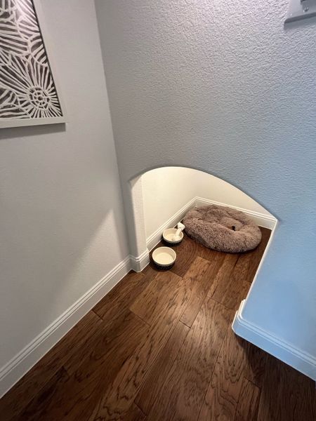 A cozy pet nook with hardwood floors and a fluffy bed, perfect for your furry friend's comfort. A cozy pet nook with hardwood floors and a fluffy bed, perfect for your furry friend's comfort.
