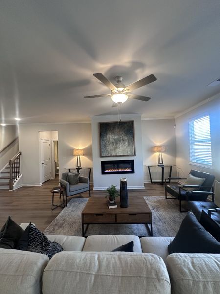A cozy living room featuring a modern fireplace, plush seating, and warm lighting.