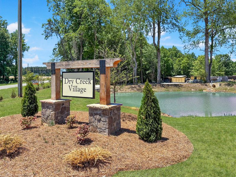 Entrance to the Dry Creek Village community in Lillington, NC, featuring signage and landscaping (Image 1). Entrance to the Dry Creek Village community in Lillington, NC, featuring signage and landscaping (Image 1).