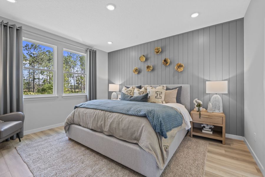 Coronado Model Home Primary Bedroom with Large Bed at Reserve East in Flagler Beach