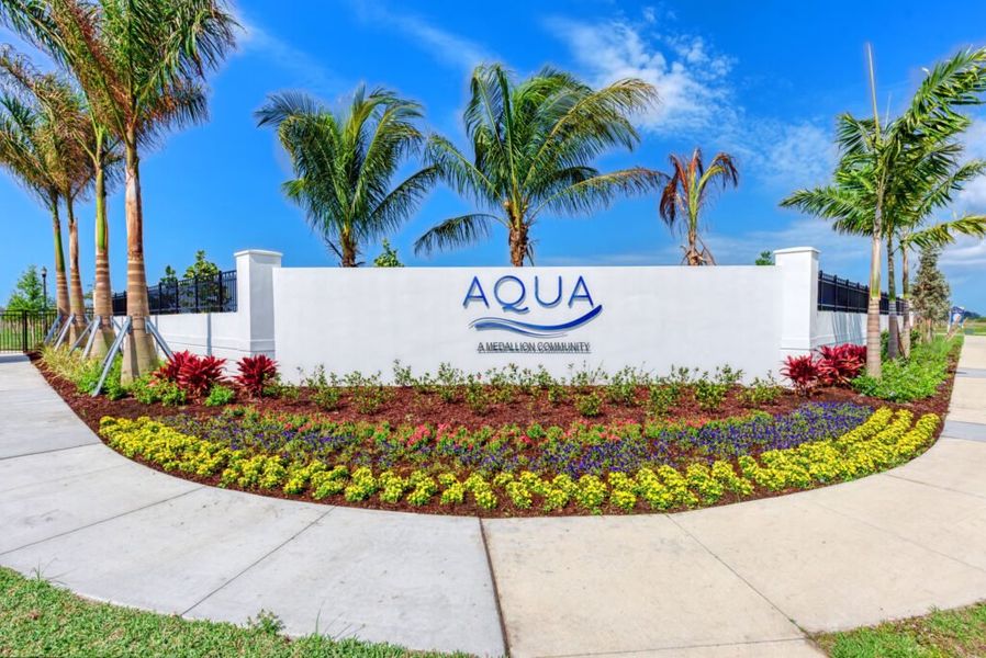 Entrance to the Aqua community in Bradenton, FL, featuring signage and landscaping (Image 2).