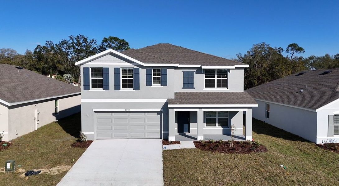 A modern gray two-story home with elegant shutters in Autumn Glen by D.R. Horton, Belleview, FL.