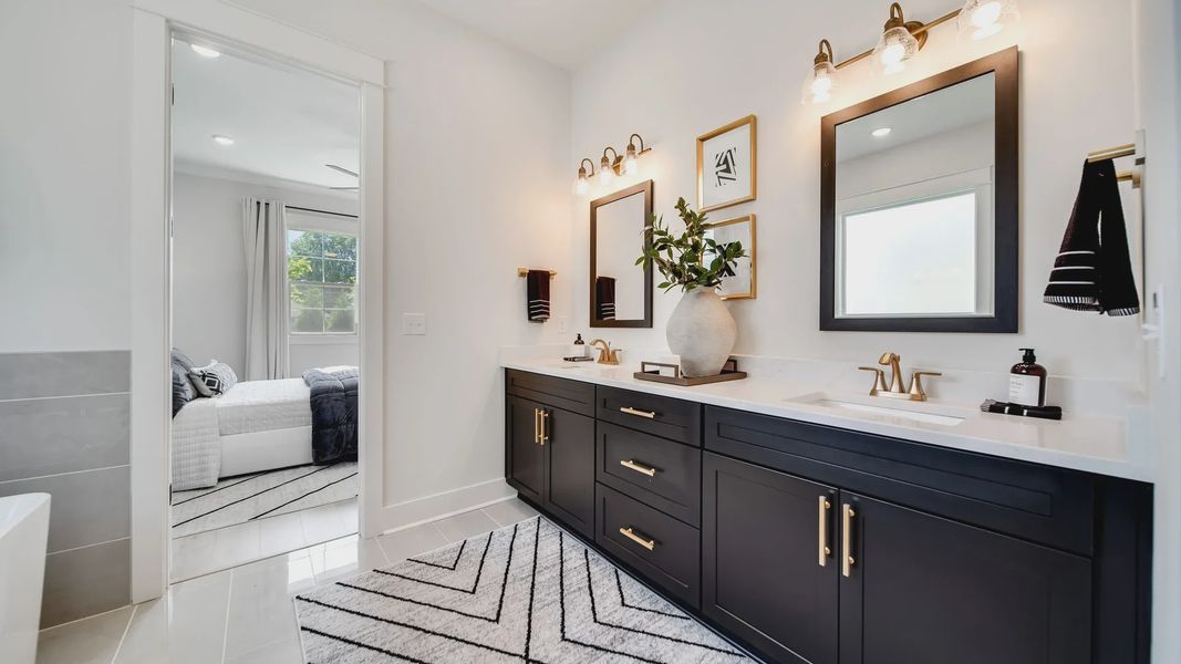 Experience refined luxury with marble countertops and dark cabinetry in Shelton Square's exquisite bathroom.