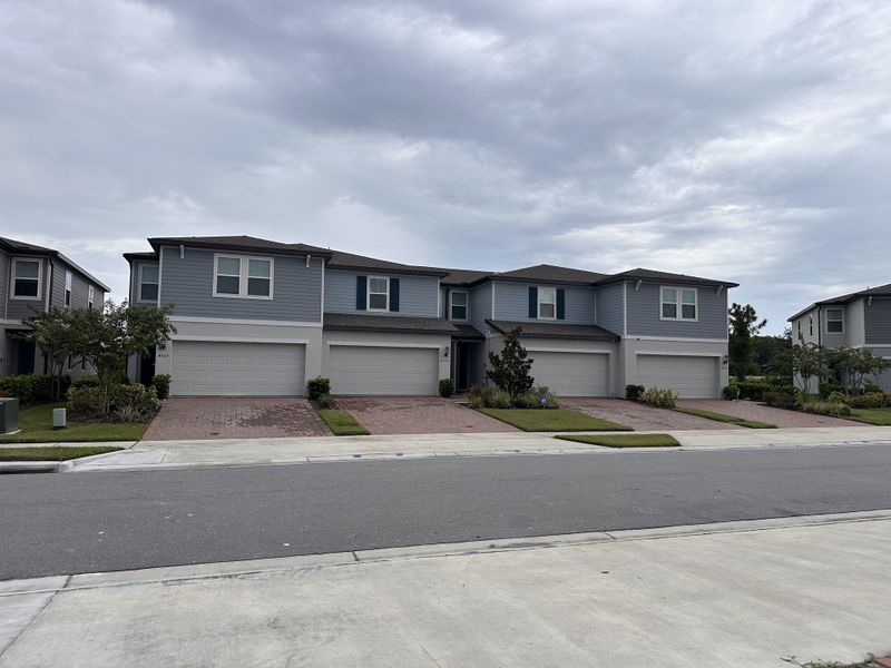 A modern gray townhome with matching garage doors in Eden at Crossprairie by M/I Homes (St. Cloud, FL). A modern gray townhome with matching garage doors in Eden at Crossprairie by M/I Homes (St. Cloud, FL).