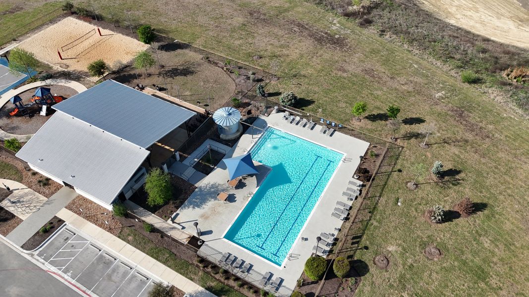 Aerial view of community amenities with pool and sports facilities in TRACE by Terrata Homes (San Marcos, TX).
