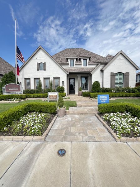 A beautiful white brick home with a manicured garden in Devonshire by Highland Homes (Forney, TX). A beautiful white brick home with a manicured garden in Devonshire by Highland Homes (Forney, TX).