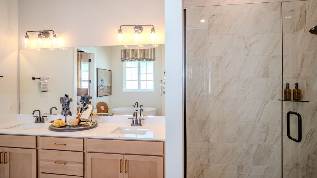 Bathroom with dual vanity and glass enclosed shower
