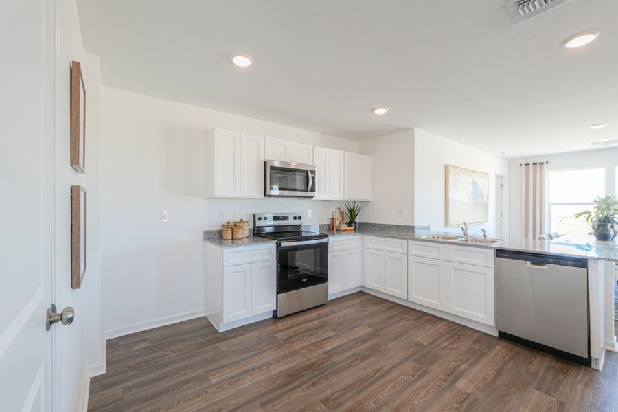 A kitchen with white cabinets. A kitchen with white cabinets.