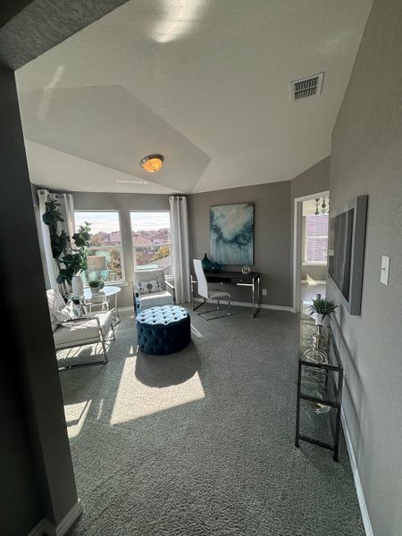 A cozy home office nook with modern furnishings, ample natural light, and serene artwork. A cozy home office nook with modern furnishings, ample natural light, and serene artwork.