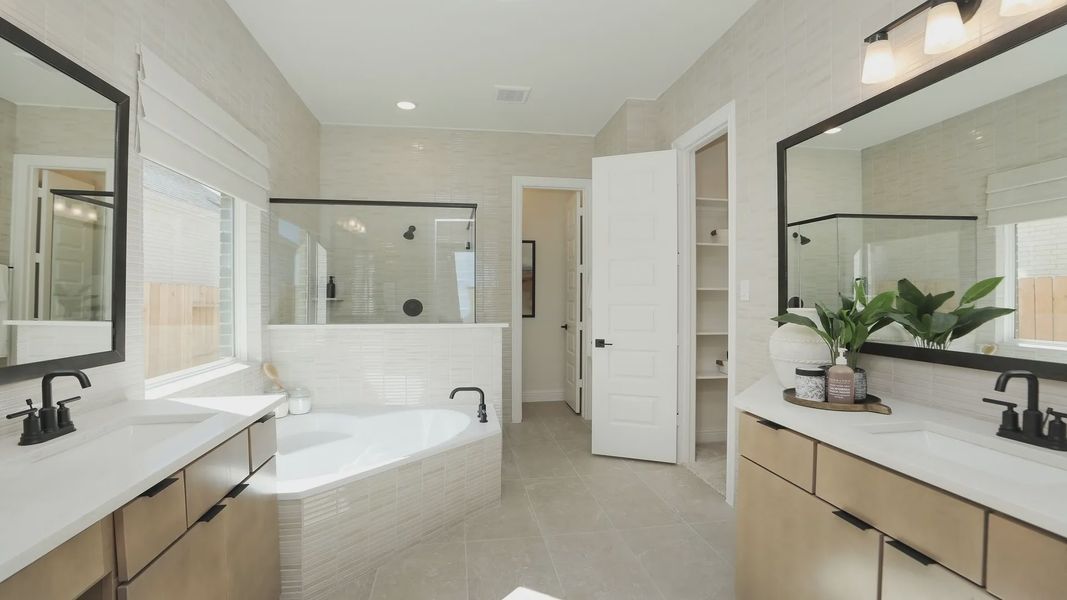 Luxurious Brookewater bathroom with marble tiles, dual vanity, and frameless glass shower. Opulent design elements. Luxurious Brookewater bathroom with marble tiles, dual vanity, and frameless glass shower. Opulent design elements.