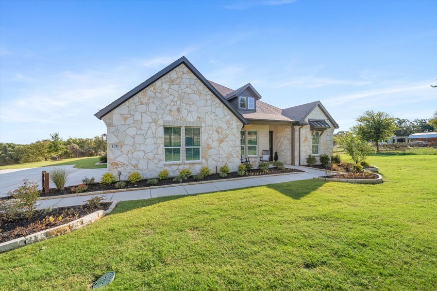 Front exterior of a home in the Oak Grove Addition community, located in Springtown, TX (Image 8).