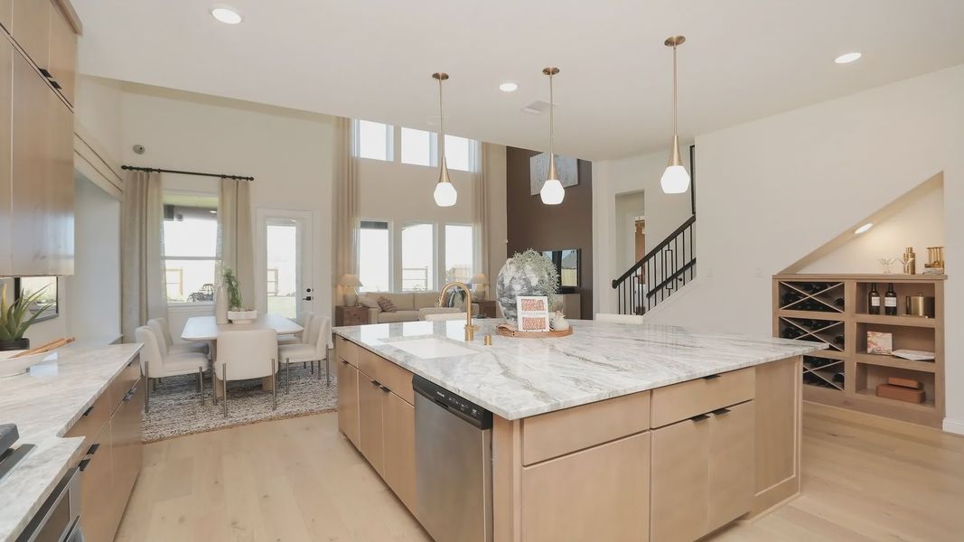 Elegant marble countertops and pendant lights highlight this exquisite kitchen in Brookewater community. Elegant marble countertops and pendant lights highlight this exquisite kitchen in Brookewater community.