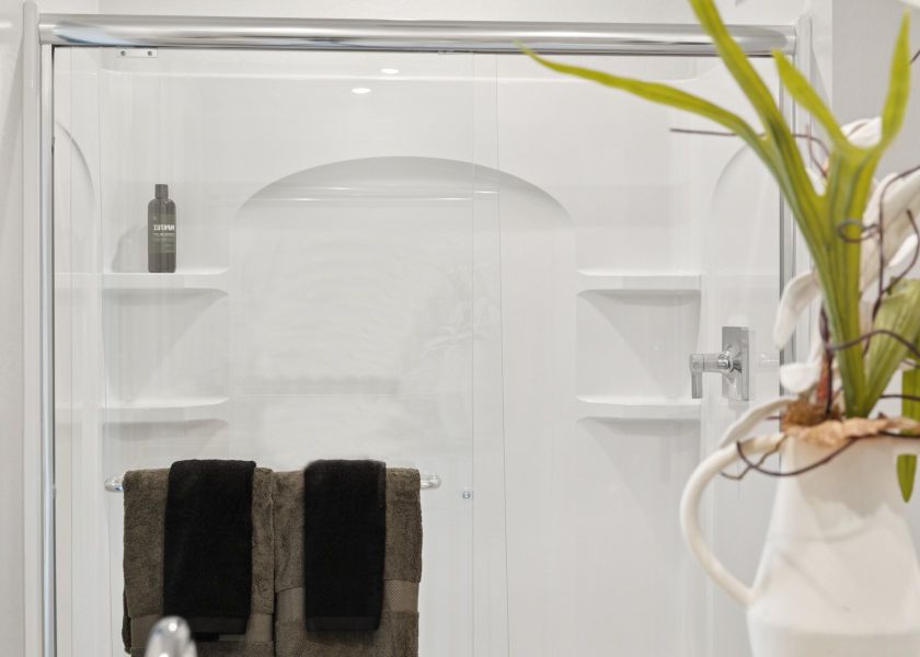 A shower with a plant in it. A shower with a plant in it.