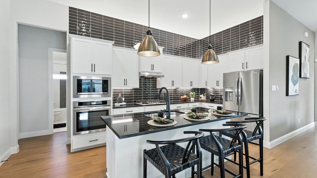 Elegant kitchen features sleek black countertops and pendant lighting. Located in prestigious Green Oaks Preserve. Elegant kitchen features sleek black countertops and pendant lighting. Located in prestigious Green Oaks Preserve.