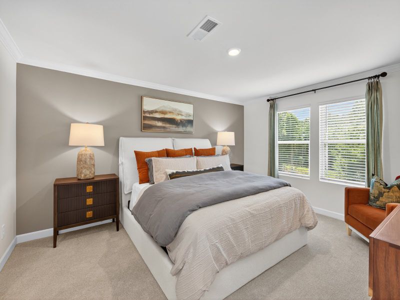 Relax and unwind after a long day in the spacious primary bedroom.